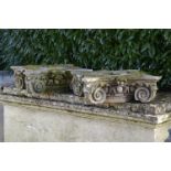 A pair of carved Bathstone ionic order capitals    18th century  64cm.; 25ins square