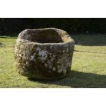 A carved stone cylindrical trough    60cm.; 24ins high by 83cm.; 33ins diameter