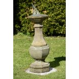 A carved Hamstone sundial  19th century with 11in octagonal dial indistinctly inscribed