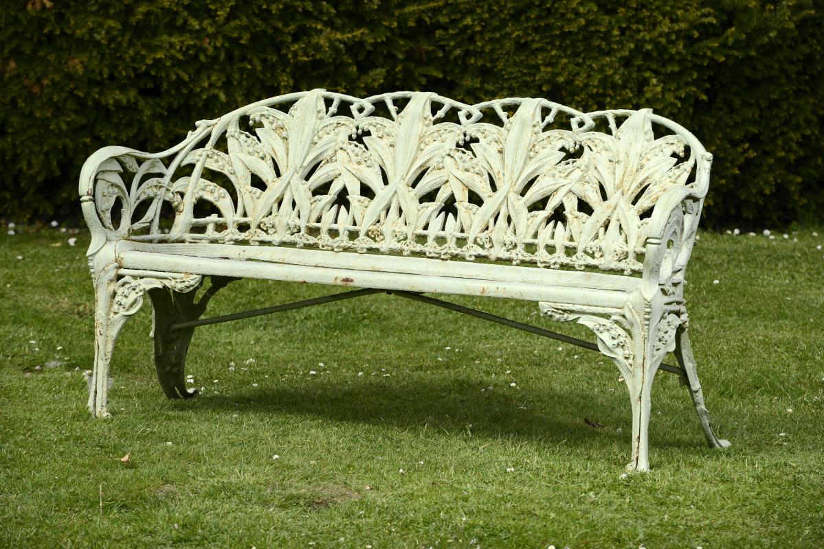 Garden Seat:A similar Coalbrookdale Lily of the Valley pattern cast iron seat  157cm.; 62ins long