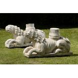 Garden Sculpture:Two Romanesque style carved marble recumbant lions  late 19th/20th century 55cm.;