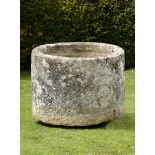 A large cylindrical carved limestone trough  81cm.; 32ins high by 115cm.; 45ins diameter