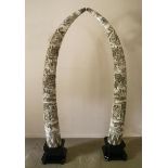 A pair of Imitation Elephant Tusks  Carved water buffalo horn 220cm.; 86½ins high by 60cm.; 23½ins