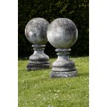 A pair of composition stone gatepier balls  early 20th century 74cm.; 29ins high