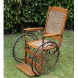 A Three -Wheeler Oak Berger wheel Chair  105cm.; 41½ins high by 68cm.; 26¾ins wide by 115cm.; 45¼ins