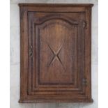 A oak corner cupboard  late 18th century with inlaid decoration