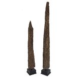 Two Mussel Poles  mounted on Ebony wood block stands 180cm.; 71ins high by 22cm.; 8½ins wide by