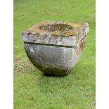 An unusual carved limestone quern stone  18th century or earlier 68cm.; 27ins high