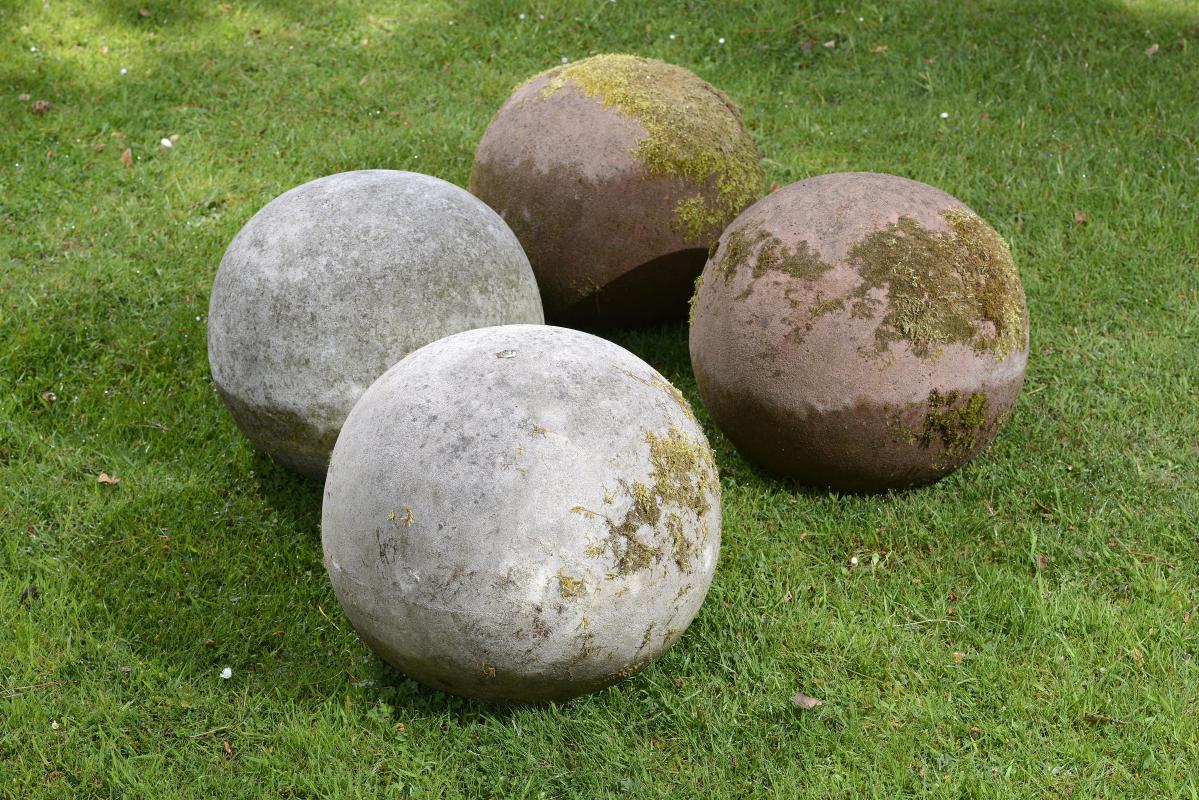 A similar pair of red composition stone gatepier balls  mid 20th century 38cm.; 15ins