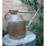 A heavy copper watering can  French, circa 1910 with associated rose 46cm.;  18ins high