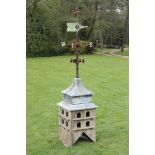 A wrought iron and copper weathervane  circa 1880 on later wooden dove cote base  287cm.; 113ins