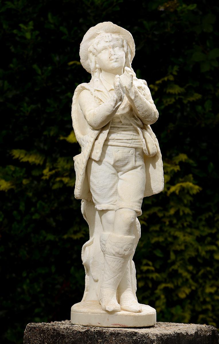 Garden Statue: A carved white marble figure of a boy in shepherd’s dress102cm.; 40ins high