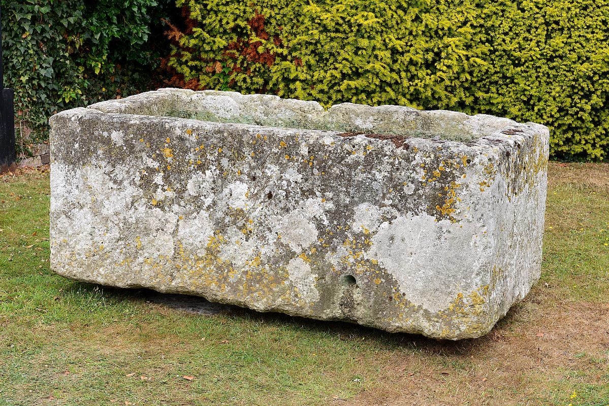 A substantial carved stone trough80cm.; 31ins high by 210cm.; 83ins long by 100cm.; 39ins deep