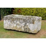 A substantial carved stone trough80cm.; 31ins high by 210cm.; 83ins long by 100cm.; 39ins deep