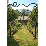 A wrought iron entranceway incorporating a pair of gates  late 20th century the opening 280cm.;