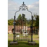 An impressive wrought iron entranceway  late 19th/early 20th century now set on York stone blocks