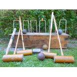 An F H Ayres Wimbledon croquet set  English,  circa 1925 comprising four mallets,  balls,  hoops and