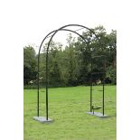 A late Georgian reeded wrought iron rose arch  early 19th century now set on slate base with boot