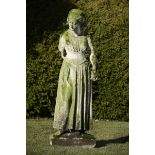 Garden Statuary: A carved Portland stone figure of a girl in Elizabethan dress holding a model