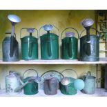 Horticulture: A collection of ten vintage watering cans finished in green paint  English and