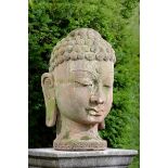 Garden Sculpture: A carved stone Buddha head  Indian,  20th century 64cm.; 25ins high