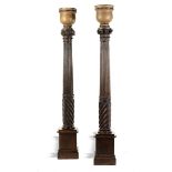 A pair of oak pedestal column lamps  Northern European,  20th century 198cm.; 78ins high