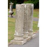 A set of three carved stone column pedestals  19th century 130cm.; 51ins high