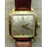 A 20TH CENTURY 18CT GOLD ALPINA WRISTWATCH Having a leather strap, square face and silvered dial.