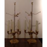 A PAIR OF CLASSICAL STYLE ADJUSTABLE GILT BRASS TABLE LAMPS  The finials in the form of eagles above