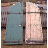 A PAIR OF VICTORIAN GOTHIC ARCH  Pine doors with heavy iron hinges.