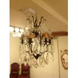 A FRENCH DESIGN SIX BRANCH CHANDELIER  Hung with numerous prisms. (57cm) Condition: good