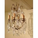 A FRENCH DESIGN SIX BRANCH CHANDELIER  Hung with numerous prisms. (57cm) Condition: good