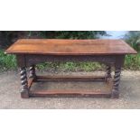 A 17TH CENTURY OAK REFECTORY TABLE The elm top above a carved frieze and raised on barley twist