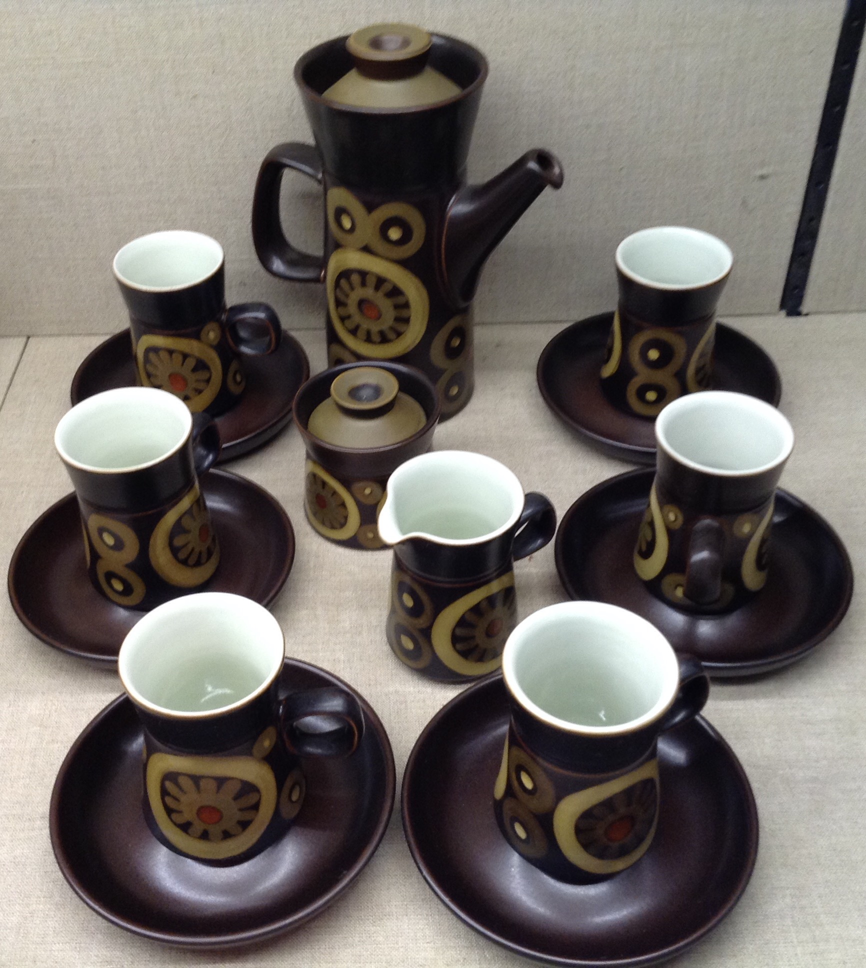 A 1970'S DENBY ARABESQUE PATTERN COFFEE SERVICE Comprising a coffee pot, a sugar and cream and six