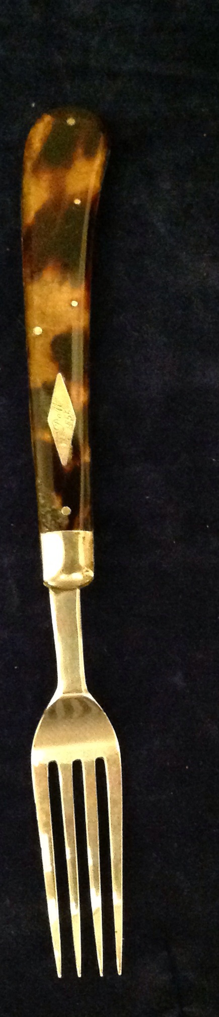 A 19TH CENTURY SOLID SILVER FORK Having a tortoiseshell handle with an inlaid silver lozenge,