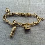 AN 18CT GOLD CHARM BRACELET Hung with three gold charms