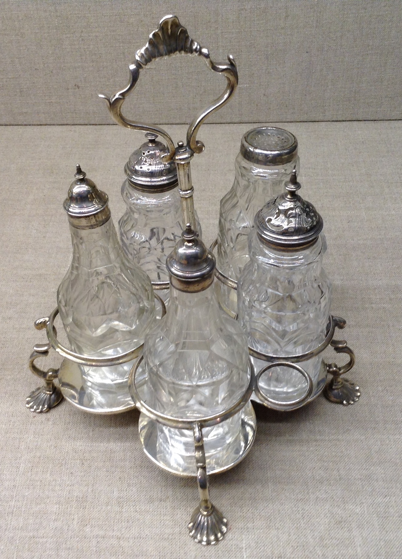 A GEORGIAN SILVER FIVE PIECE CRUET STAND 'I.D.'(?), London, 1763, complete with five matching cut