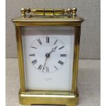 S.H. SMITH, PARIS A large 20th Century brass carriage clock, having glass panels, a white dial