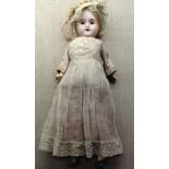 S.F.B.J., PARIS An early 20th Century Bisque headed doll, dressed in period clothing with bonnet and