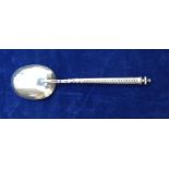 AN 18TH CENTURY SILVER SPOON Having a turned finial above a twisted stem, the bowl engraved with a