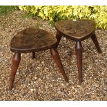 A PAIR OF EARLY 20TH CENTURY WEST COUNTRY STOOLS The seats carved with a heraldic dragon and an