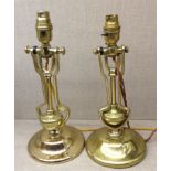 TWO EARLY 20TH CENTURY HEAVY BRASS CANDLESTICK LAMPS One with movable pivot (electrified)