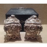 A CASED PAIR OF GEORGE III NEO-ROCOCO CHINOISERIE SILVER TEA CADDIES By John Wakefield, London,