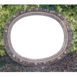 A 19TH CENTURY OVAL GILT FRAMED MIRROR With heavy moulded decoration (AF), together with a small