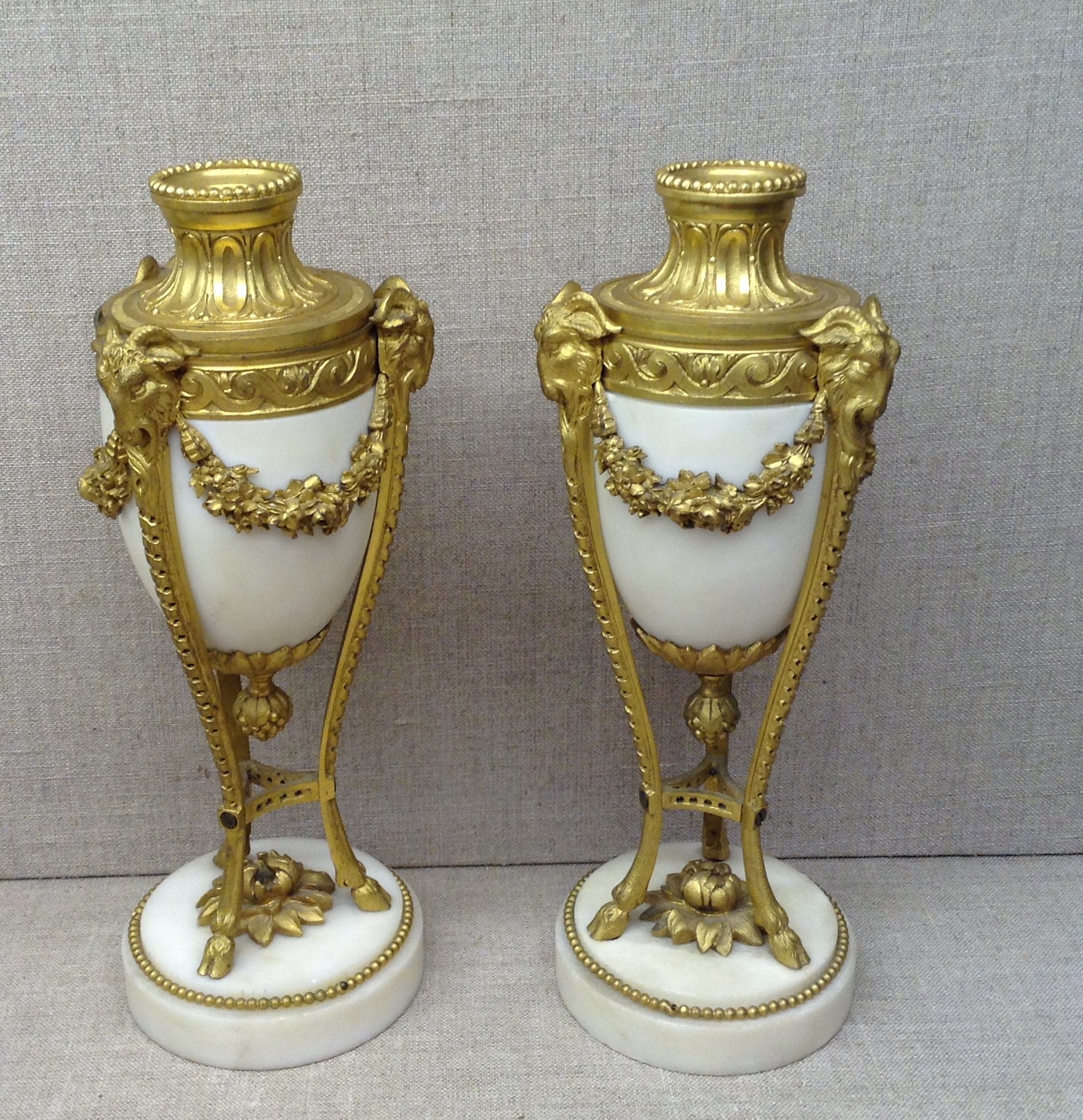 A PAIR OF 19TH CENTURY URN SHAPED CASSOLETTE CANDLESTICKS Having white marble and gilt bronze