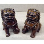 A PAIR OF BROWN GLAZED TEMPLE DOGS OF FO. (h 13cm)