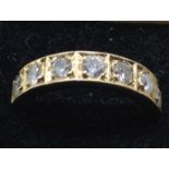 A 9CT GOLD SEVEN STONE DIAMOND HALF ETERNITY RING. (4g)