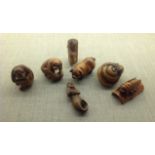 A COLLECTION OF SEVEN 20TH CENTURY JAPANESE ORIENTAL NETSUKE CARVINGS Made from tagua nuts, each