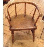 A LATE 19TH/EARLY 20TH CENTURY ELM AND ASH CHILD'S CHAIR Having a bow back and raised on turned