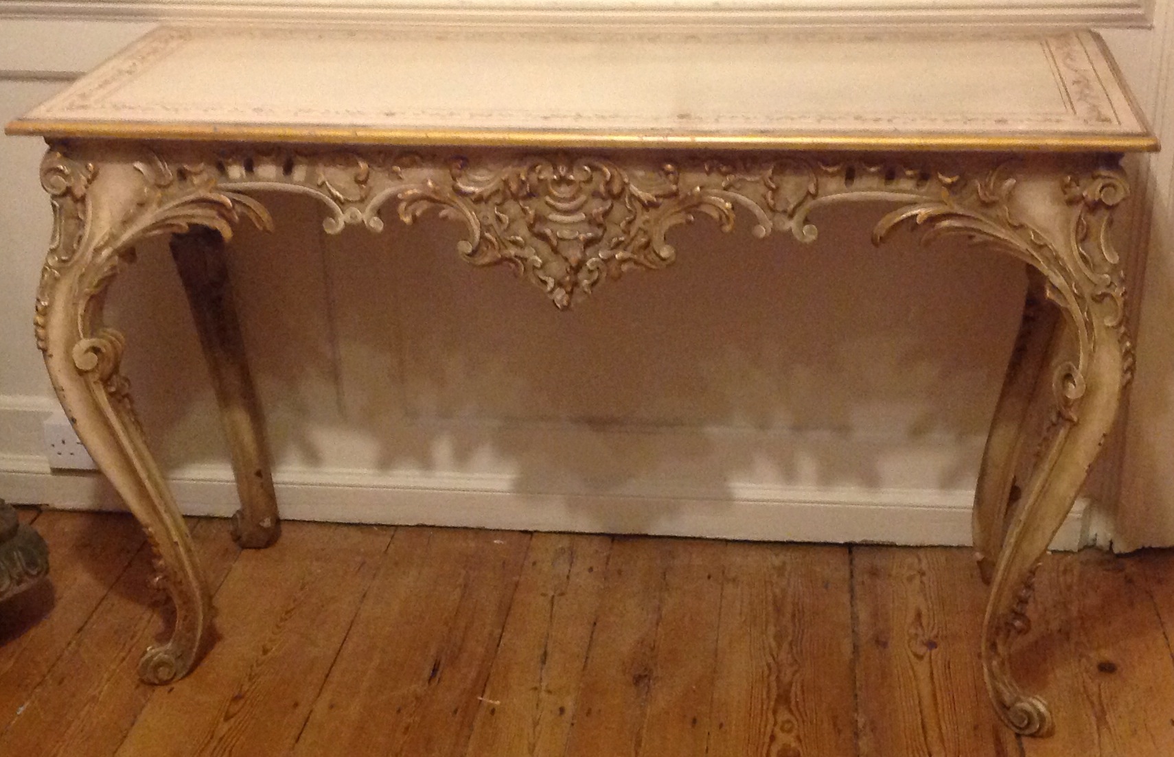 A 19TH CENTURY ITALIAN CONSOLE TABLE In original cream painted finish, the floral border above a